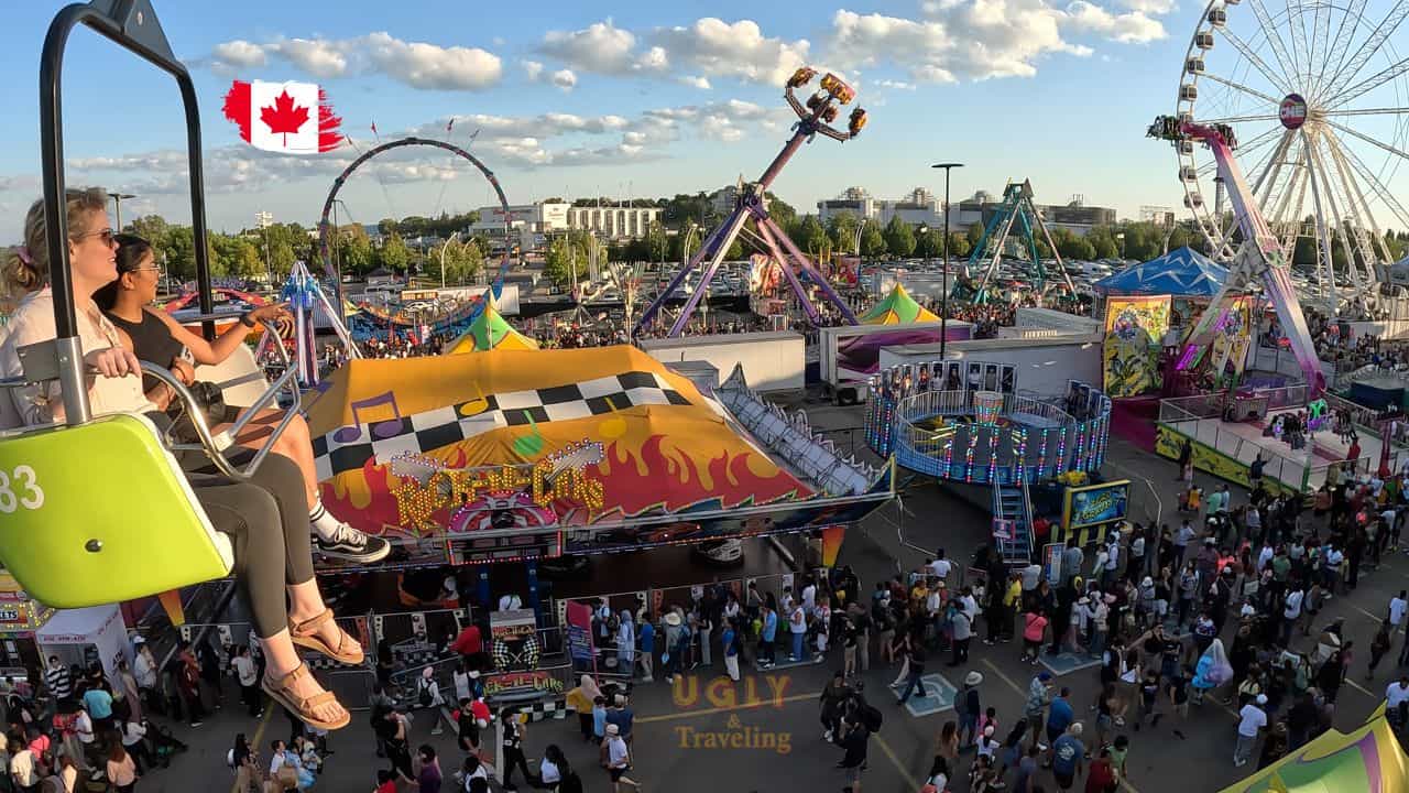 Colorful amusement park rides at a lively fair in Canada, full of visitors enjoying the fun and vibrant atmosphere.